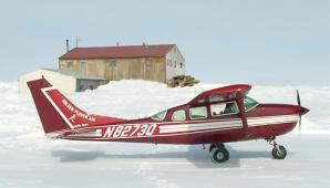 Cessna-206 on wheels on river ice